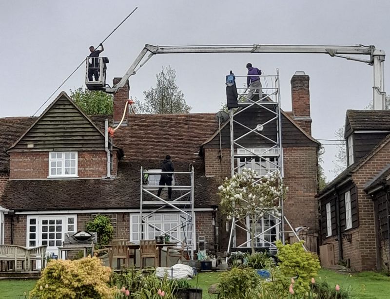 The Roof Moss Cleaners using cherry picker and scaffolding to clean roof safely and professionally in Twyford, Berkshire